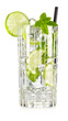 Fresh mojito cocktail in tall crystal tumbler garnished with lime slice and mint leaves isolated on white background.