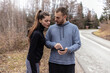© Jelena Stanojkovic - Young people checking their fitness progress on smartphone. Two young people checking their fitness progress on a smartphone app after a morning run.