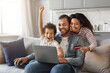© Prostock-studio - Happy Black Family With Laptop And Credit Card Making Shopping At Home