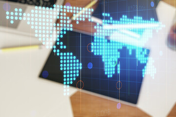 Wall Mural - multi exposure of abstract graphic world map and modern digital tablet on desktop on background, top
