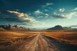 A dusty dirt road winds through the vast desert landscape, with mountains in the distance and a colorful sunset painting the sky above