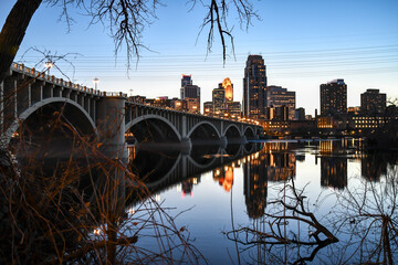 Wall Mural - City bridge and lights reflection in the river water at dusk