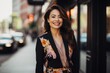 © aicandy - A confident, stylish woman in her mid-30s, wearing a vibrant floral A-line skirt paired with a sleek black blazer, standing in a bustling city street, her radiant smile shining like the sun