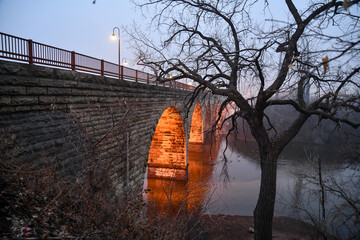 Wall Mural - Old stone arch bridge across the Mississippi river 