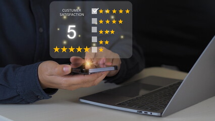 Wall Mural - close up Man hand using mobile with popup five star icon for feedback review satisfaction service, Customer service experience and business satisfaction survey.