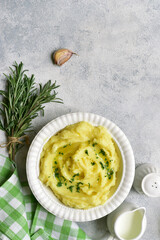 Wall Mural - Mashed potato in mediterranean style with rosemary, parmesan cheese, garlic and olive oil. Top view with copy space.