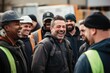 Group of happy construction workers laughing together on site
