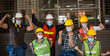 © winnievinzence - Group of diversity construction workers wearing protective mask celebrating for success project at the industry factory.
