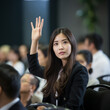 © javaistan - Asian businesswoman raising hand to ask question attending seminar in conference hall