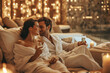 © colnihko - Couple in love enjoys a romantic spa experience with champagne and ambient candle lighting