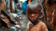 A little African American boy against the background of slums and poverty