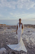 © Slava_Vladzimirska - beautiful bride in luxurious wedding dress posing on the beach in Cyprus