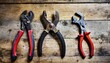old pliers pincers and adjustable wrench on an old wooden workbench old work tools