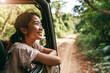 Happy asian woman traveling opens window to breathe fresh air of nature, Female enjoy travel in outdoor lifestyle activity on road trip vacation