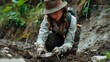 Archaeologist using a sieve to sift through soil and recover smaller artifacts and botanical remains. [Archaeologist sieving soil for smaller artifacts