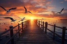  A Pier With Seagulls Flying Over The Water And The Sun Setting In The Distance With Clouds In The Sky.