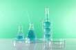 © New Africa - Laboratory analysis. Different glassware on table against green background