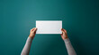 Hand holding a blank piece of paper, clean background for mockups