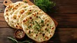 © buraratn - Indian naan bread on wooden desk