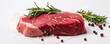 Raw beef steak on white background with salt pepper and herbs.