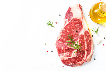 Wall Mural - Meat steak. Beef steak ribeye with spices and herbs on white background. Top view with copy space.
