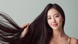 © StellaPattaya - female Asian woman with long hair, smiling, advertises hair care product
