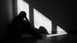 © c80 - A solitary figure, bathed in shadows and surrounded by stark black walls, sits in silent contemplation on the monochromatic floor, a haunting contrast of light and darkness