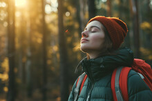 Young Woman With Eyes Closed Breathing Fresh Air While Camping In Woods