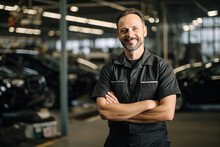 Portrait Of Truck Repair Shop Owner With Arms Crossed Looking At Camera