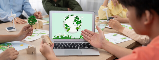 Wall Mural - Green city logo displayed on a laptop at a green business meeting. Team presenting green design to customer. ESG environment social governance and Eco conservative concept. Closeup. Delineation.