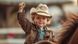 Happy smiling young cowboy riding horse at rodeo event, wearing a cowboy hat, posing with one hand raised