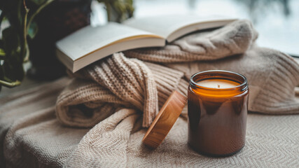 Wall Mural - Burning candle in a cozy home interior