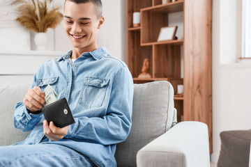 Poster - Young man with wallet and dollar banknotes at home