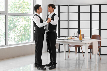 Wall Mural - Happy gay couple dancing on their wedding day