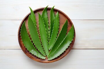 Poster - Aloe vera cut in wooden bowl with leaves on white wood background