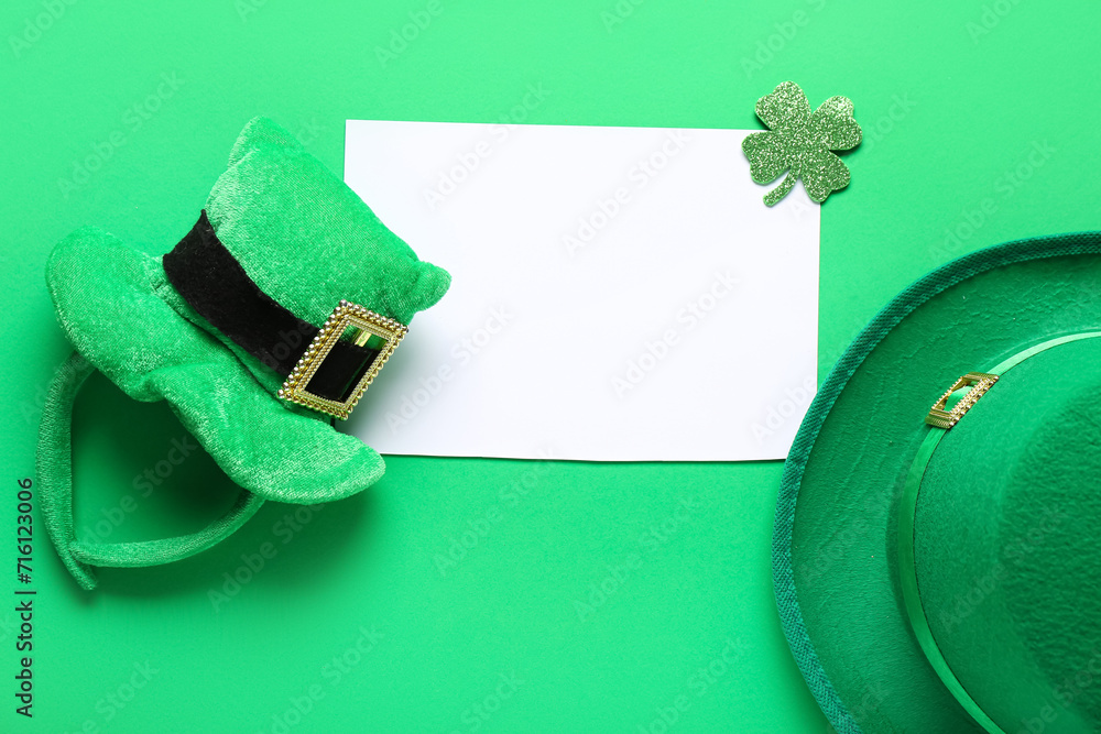 Blank card with leprechaun hats and paper clover on green background. St. Patrick's Day celebration