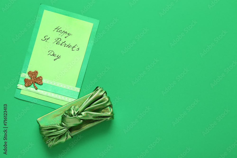 Gift box with festive card on green background. St. Patrick's Day celebration
