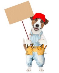 Poster - Funny Jack russell terrier puppy wearing red cap and denim overalls with tool belt holds adjustable wrench and shows empty placard. isolated on white background
