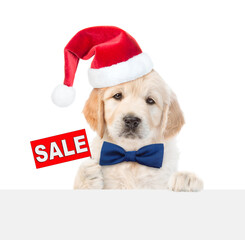 Aufkleber - Cute Golden retriever puppy wearing santa hat shows signboard with labeled 