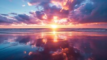 A Stunning Image Of A Vibrant Sunset With Clouds Reflected On The Wet Sand During Low Tide