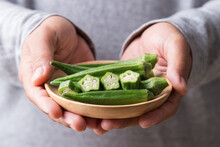 Green Okra In Wooden Bowl Holding By Hand, Healthy Vegetables