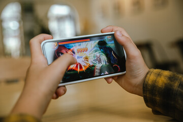 Little boy playing online game on smart phone, e-Sport Games compilation and Internet Championship.