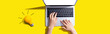 Leinwandbild Motiv Person using a laptop computer and a light bulb - Flat lay