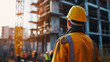 © EmmaStock - Engineer technician watching the team of workers on the high-steel platform in the construction site
