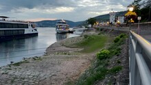 Promenade On The Rhine River In Rüdesheim, Germany. Large Tourist Ships Line The Shore. Evening Scene. Rüdesheim Is A Town On The Northern Banks Of The Rhine River In The Wine Region Of Rheingau.