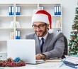 © Elnur - Young businessman celebrating christmas in the office