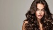 © buraratn - Brunette girl with long and shiny curly hair . Beautiful model woman with wavy hairstyle