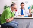 © Elnur - Old man visiting young male doctor gastroenterologist