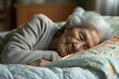 A senior woman peacefully asleep in her bed