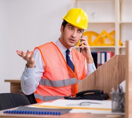 Wall Mural - Young male architect working in the office